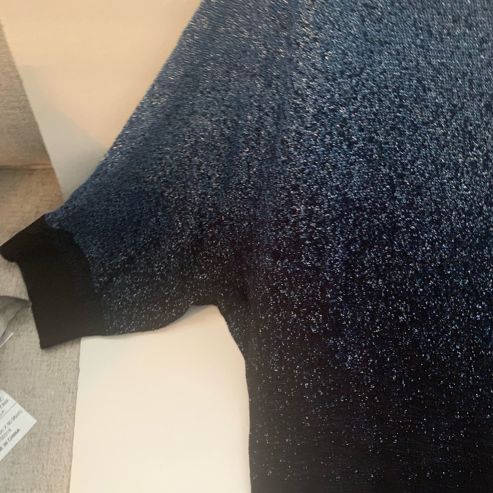 A sweater with bell sleeves two tone blue with black